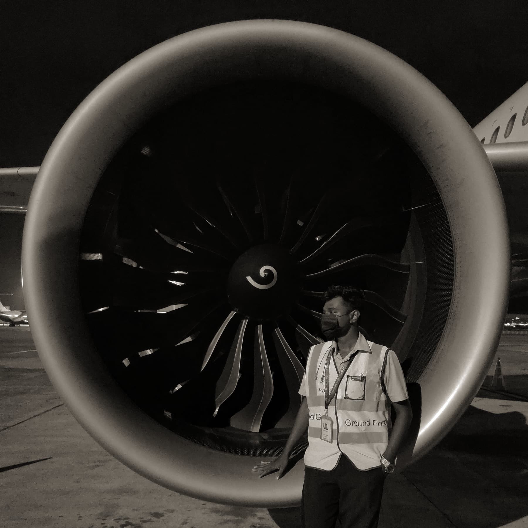 Aravinthan beside an aircraft engine during his aviation training